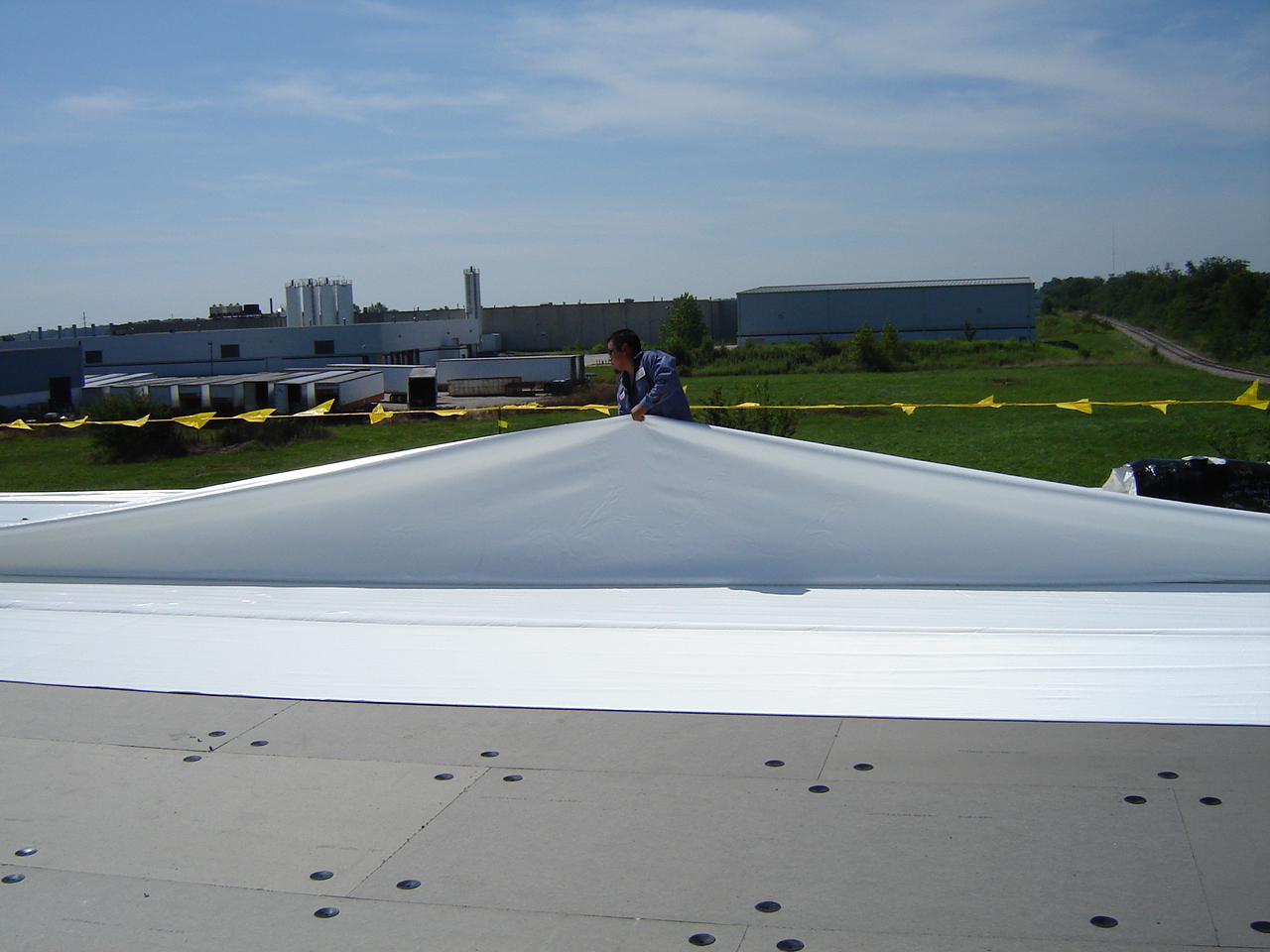 roofer working on flat roof replacement